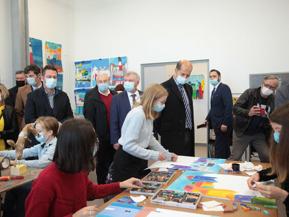 Les élus observent des jeunes lors d'un atelier d'arts plastiques.